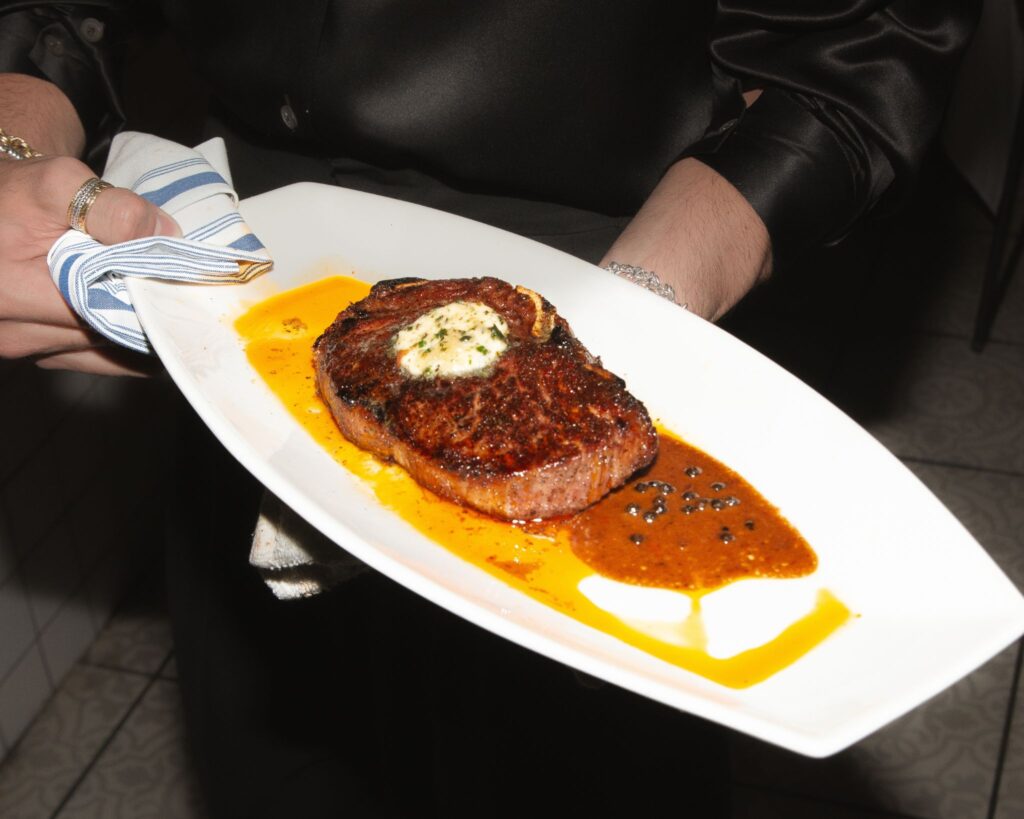 Upscale dining restaurant interior at Andrew Steak Society in NYC featuring an elegant bar and sophisticated ambiance.