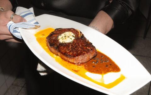 Upscale dining restaurant interior at Andrew Steak Society in NYC featuring an elegant bar and sophisticated ambiance.