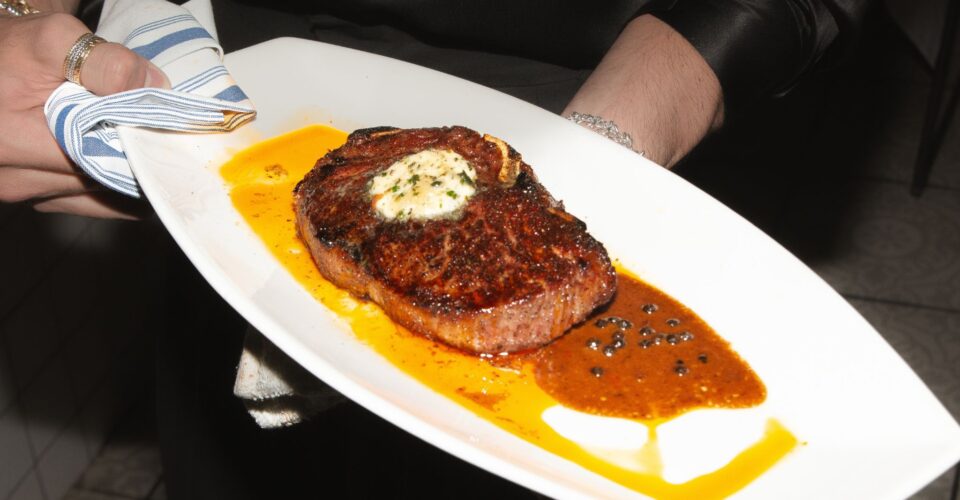Upscale dining restaurant interior at Andrew Steak Society in NYC featuring an elegant bar and sophisticated ambiance.