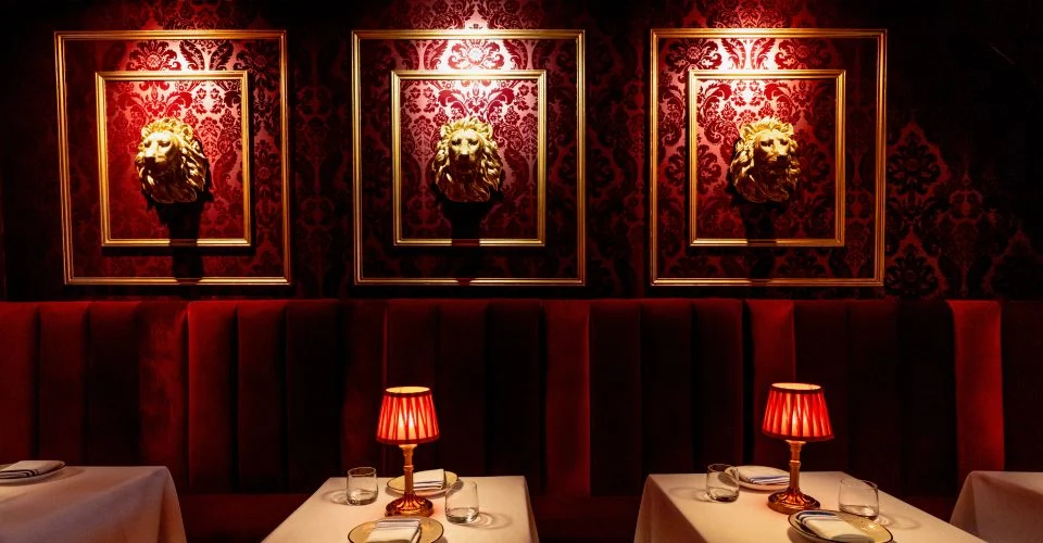 Upscale dining NYC steakhouse interior with warm lighting and elegant table settings